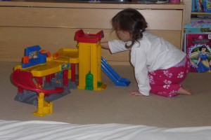 Inês playing with her toy garage